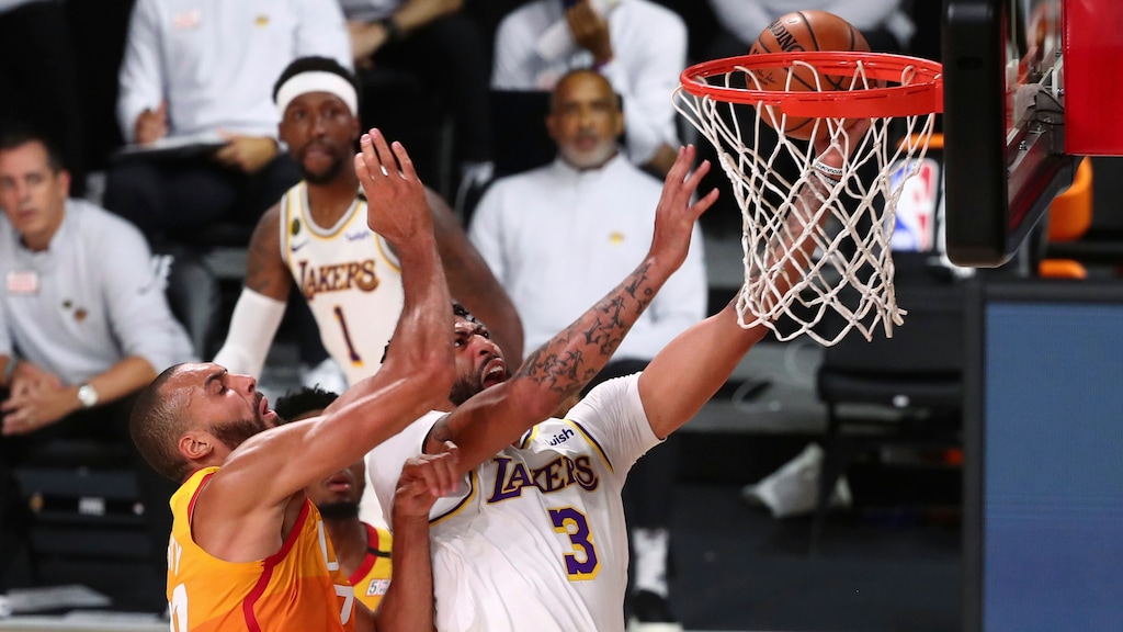 (Kim Klement | Pool via AP) Los Angeles Lakers forward Anthony Davis (3) is fouled by Utah Jazz center Rudy Gobert, left, during the first half of an NBA basketball game Monday, Aug. 3, 2020, in Lake Buena Vista, Fla.