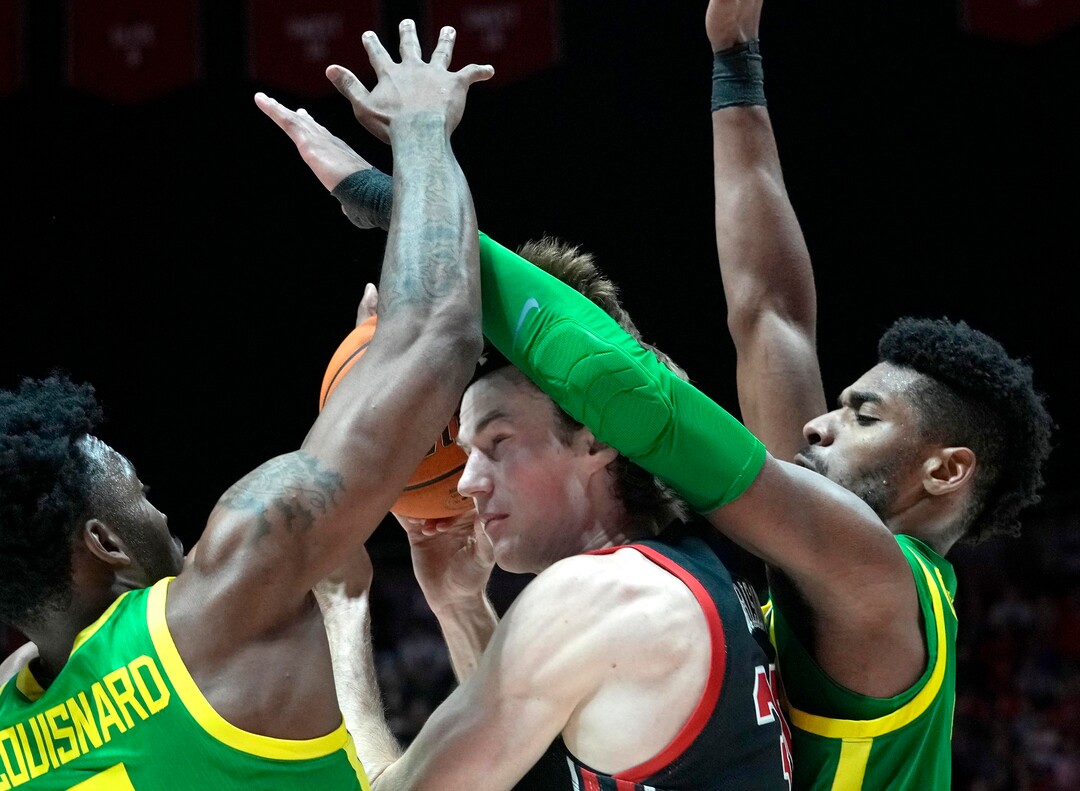 (Leah Hogsten | The Salt Lake Tribune) Oregon Ducks guard Jermaine Couisnard (5) and Oregon Ducks forward Quincy Guerrier (13) pressure Utah Utes center Branden Carlson (35) as the University of Utah hosts Oregon at the Huntsman Center, Jan. 7, 2023.