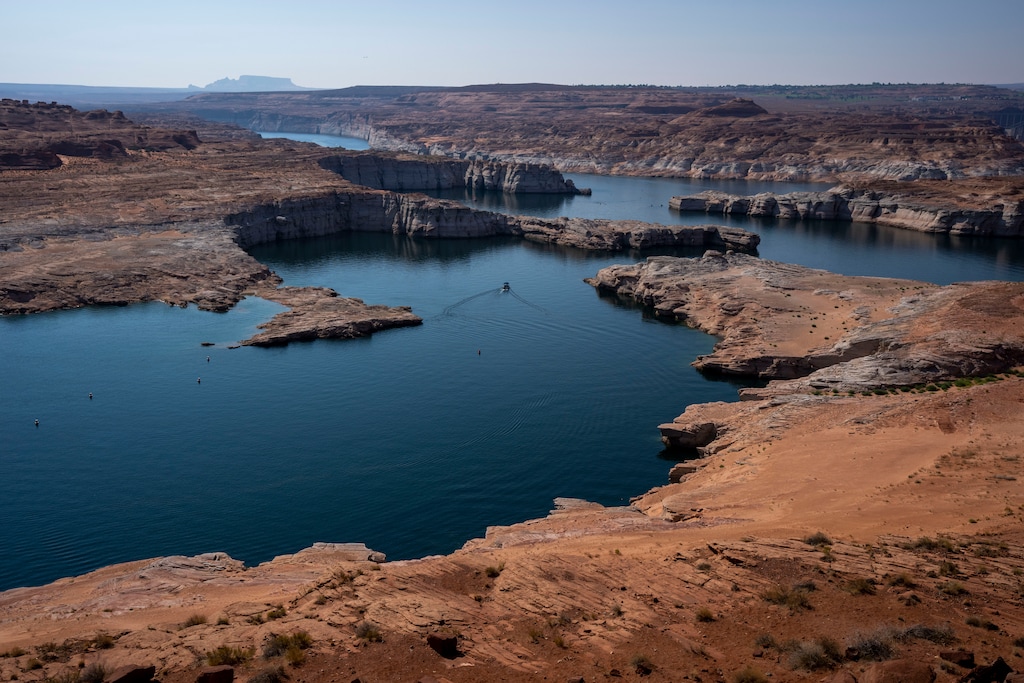 (Rick Egan | The Salt Lake Tribune)  A boat travels near the Glen Canyon Dam, on Tuesday, Aug. 3, 2021. As Lake Powell's levels continue to drop, the state of Nevada is now proposing Utah and the other states that rely on the Colorado River accept cuts totaling 500,000 acre-feet.