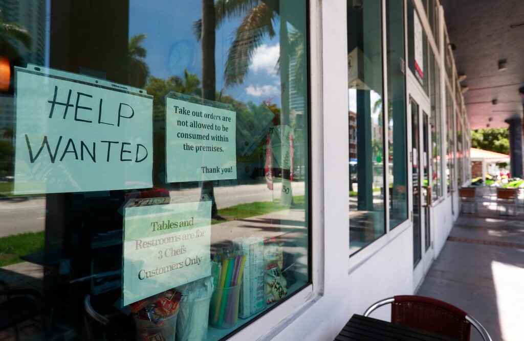 In this Monday, July 1, 2019 photo, a help wanted sign appears in the window of a restaurant in Miami. On Tuesday, July 9, the Labor Department reports on job openings and labor turnover for April. (AP Photo/Wilfredo Lee)