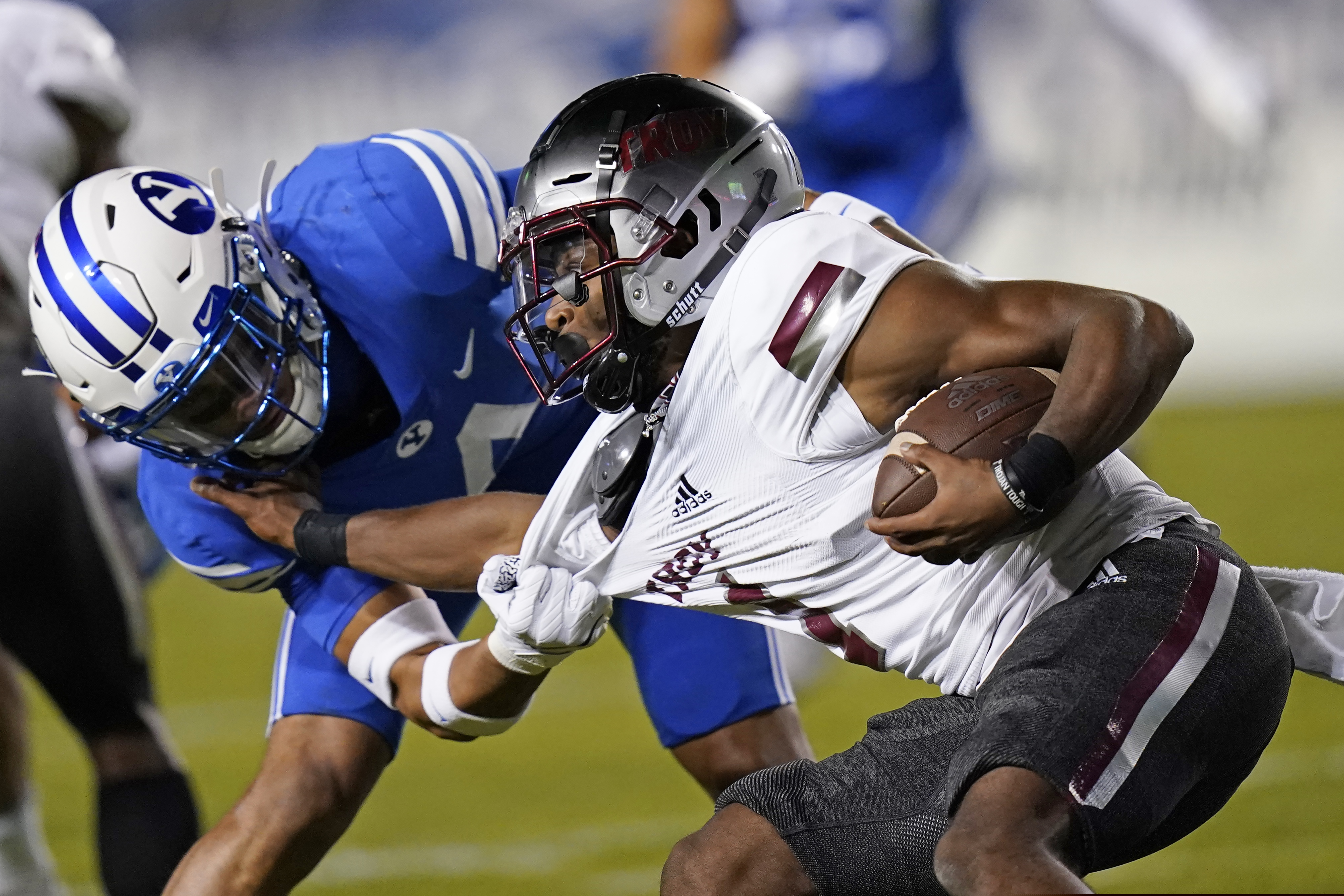 (Rick Bowmer | AP pool photo) BYU defensive back Troy Warner (4) tackles Troy wide receiver Kaylon Geiger (1) during the second half of an NCAA college football game Saturday, Sept. 26, 2020, in Provo, Utah.