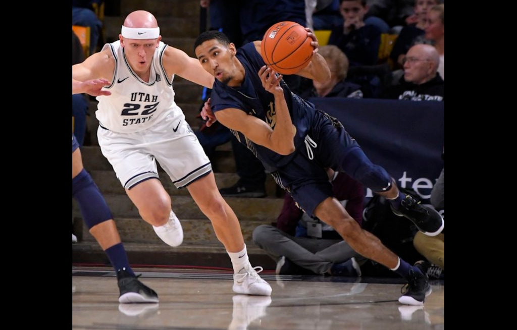 Montana State guard Mychael Paulo dribbles the ball as Utah State guard Brock Miller (22) defends during an NCAA college basketball game Tuesday, Nov. 5, 2019, in Logan, Utah. (Eli Lucero/The Herald Journal file via AP)
