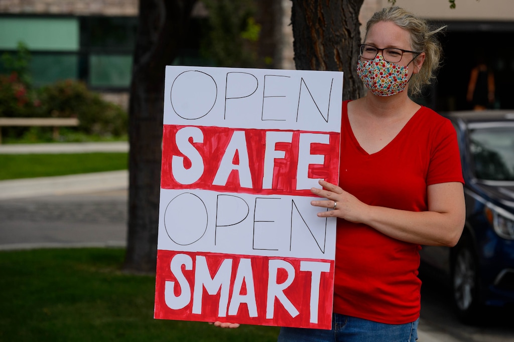 (Trent Nelson  |  The Salt Lake Tribune) Meredith Llewelyn, a teacher at Majestic Elementary School, joined other teachers and parents holding signs calling for a safe plan on reopening schools prior to a Jordan School District board meeting in Riverton on Tuesday, July 28, 2020.