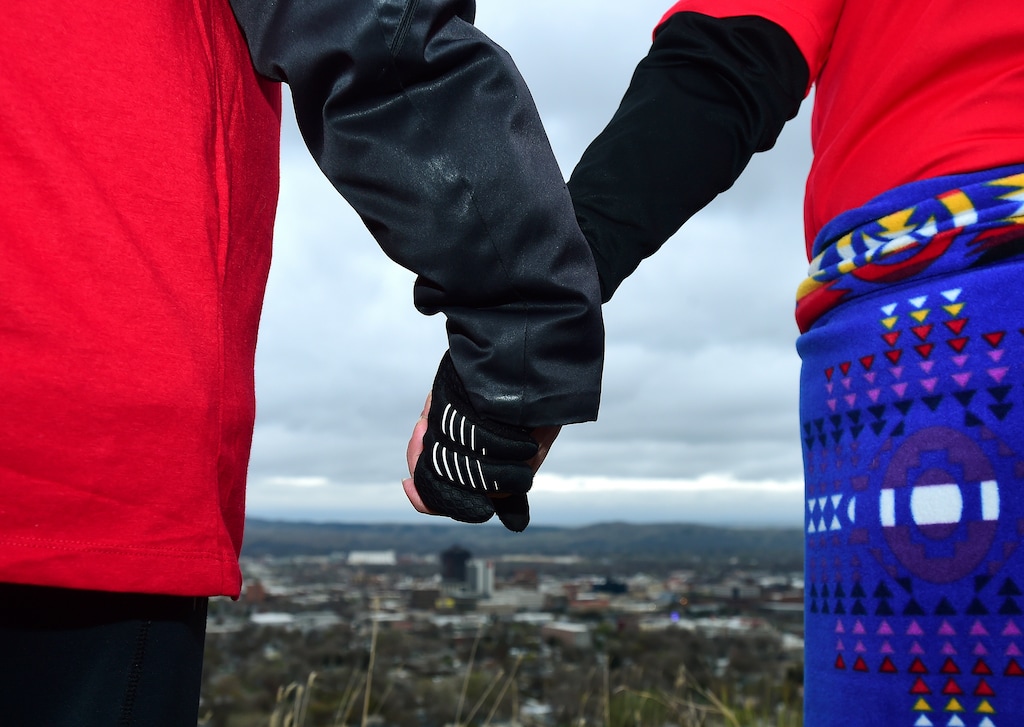 In this May 5, 2019, photo, hundreds hold hands as they form a line of the edge of the Billings Rimrocks for Line the Rims in Red event to honor missing and murdered indigenous people.