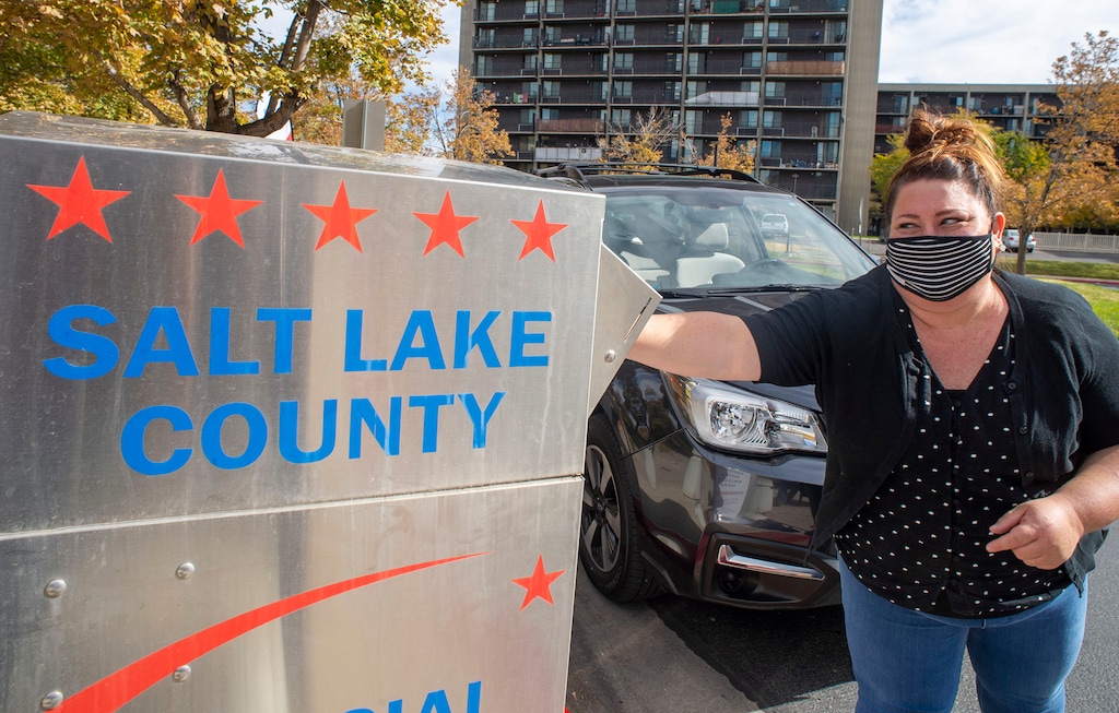 (Rick Egan  |  Tribune file poto)    Jackie Drury drops her ballot in the vote-by-mail drop box at the Salt Lake County Government Center on Monday, Oct. 19, 2020. Making such drop boxes available is a part of a sweeping Democratic election reform measure.