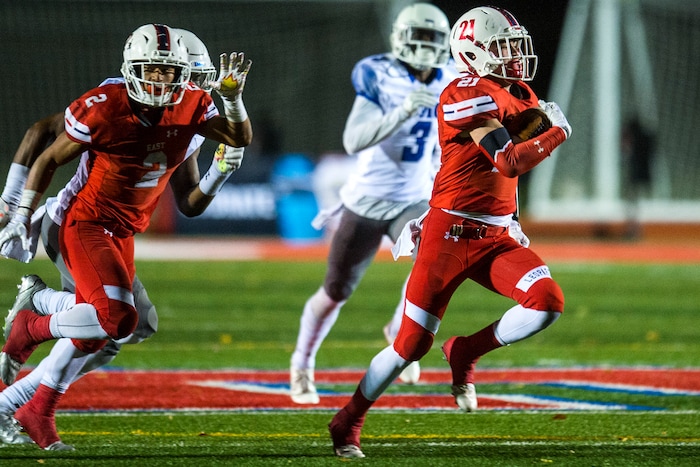 (Chris Detrick  |  The Salt Lake Tribune)  East's Charlie Vincent (21) runs past IMG Academy's Houston Griffith (3) during the game at East High School Friday, October 20, 2017. 