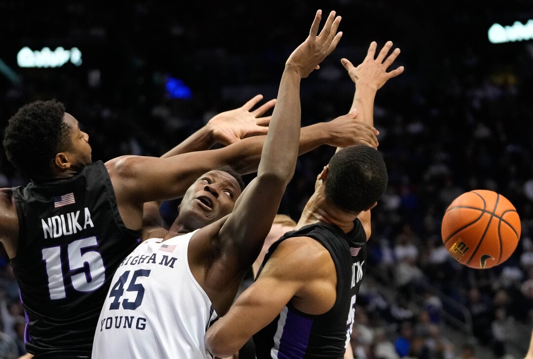(Francisco Kjolseth | The Salt Lake Tribune) Brigham Young Cougars forward Fousseyni Traore (45) battles Portland Pilots guard Chika Nduka (15) and Portland Pilots guard Chris Austin (5) in WCC basketball action between the Brigham Young Cougars and the Portland Pilots, at the Marriott Center, on Saturday, January 22, 2022.