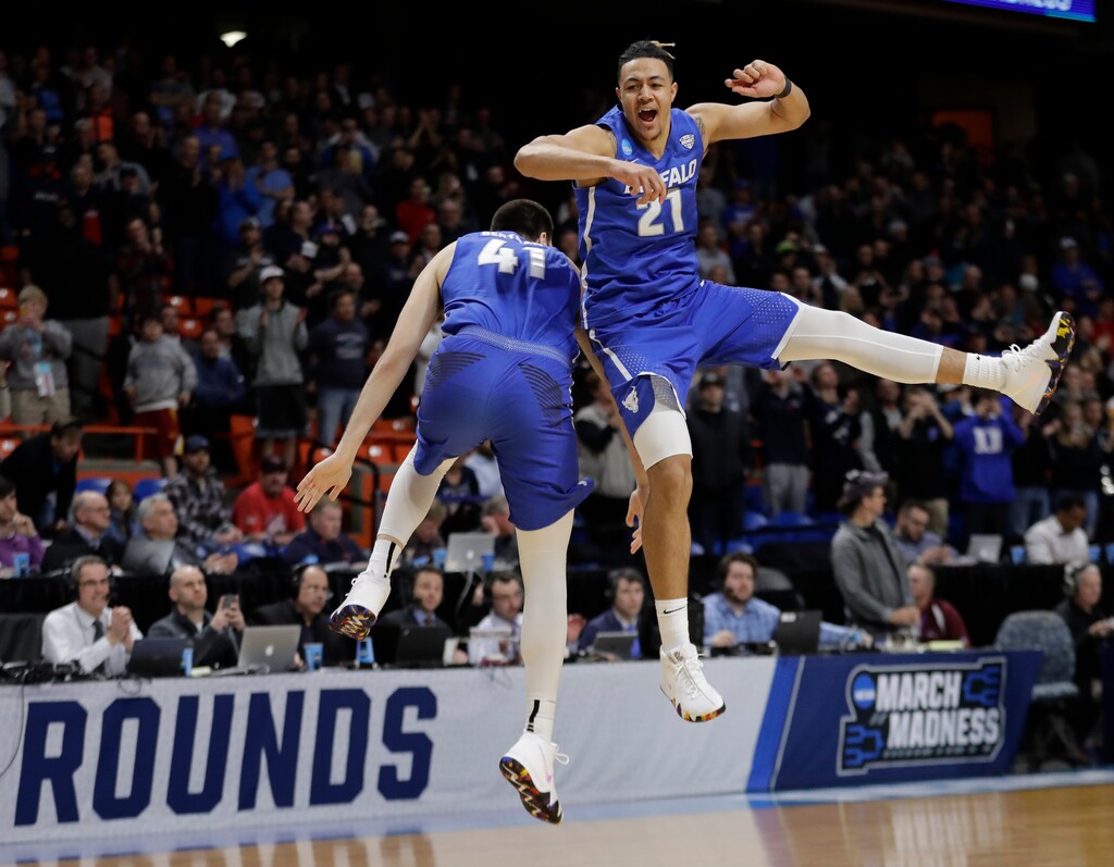 Buffalo's Dominic Johnson, right, and Brock Bertram celebrate after Buffalo upset Arizona 89-68 in first-round game in the NCAA men's college basketball tournament Thursday, March 15, 2018, in Boise, Idaho. (AP Photo/Ted S. Warren)