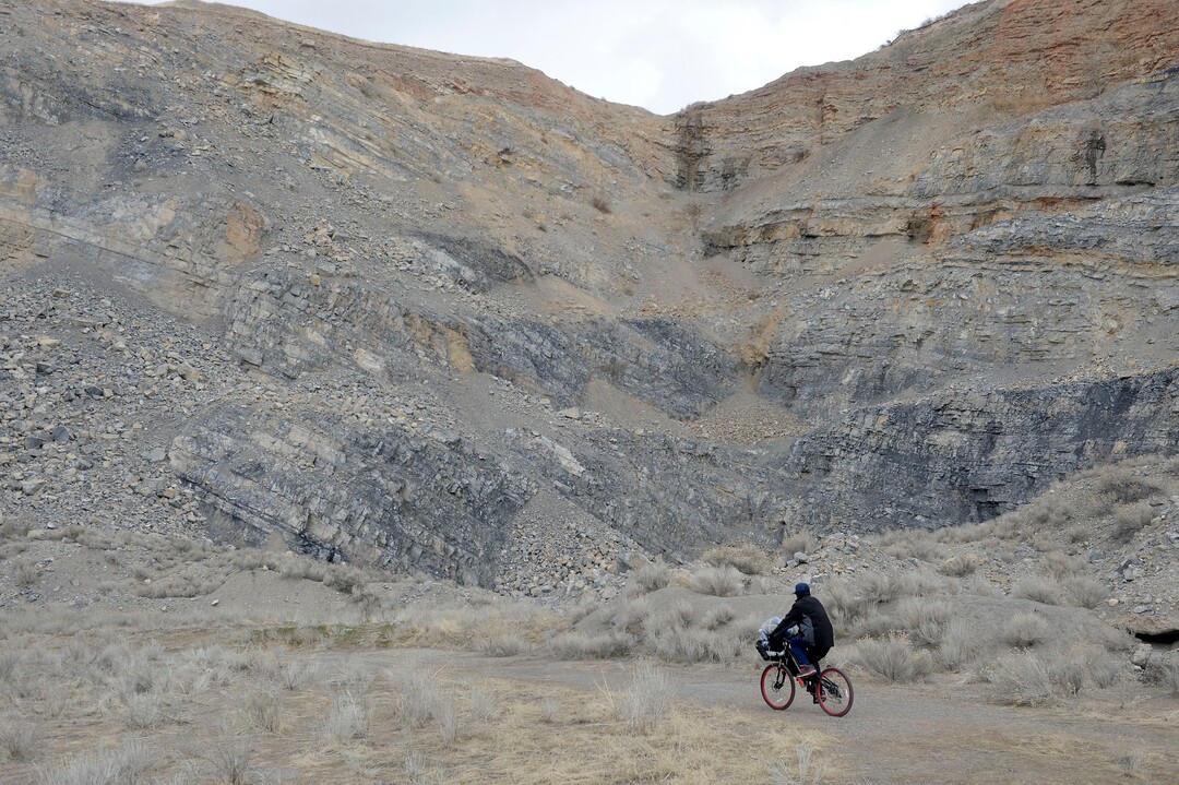 (Al Hartmann  |  The Salt Lake Tribune) 	
Ronald Ross, a homeless man rides his bike to his camp in the rocks.  He has lived in a clean, well organized tent camp for about six months on the rocky mountainside above Victory Road north of the state Capitol building.  He is waiting for a birth certificate so that he can get an identification card to apply for a job.  Salt Lake City Police, Volunteers of America, Utah Highway Patrol, and social workers from Salt Lake City and the Veterans Administration had set up a mobile outreach center along Victory Road.