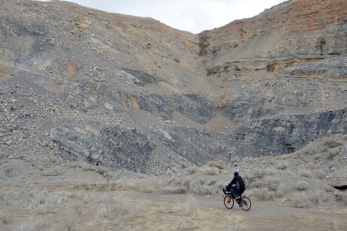 (Al Hartmann  |  The Salt Lake Tribune) 	
Ronald Ross, a homeless man rides his bike to his camp in the rocks.  He has lived in a clean, well organized tent camp for about six months on the rocky mountainside above Victory Road north of the state Capitol building.  He is waiting for a birth certificate so that he can get an identification card to apply for a job.  Salt Lake City Police, Volunteers of America, Utah Highway Patrol, and social workers from Salt Lake City and the Veterans Administration had set up a mobile outreach center along Victory Road.