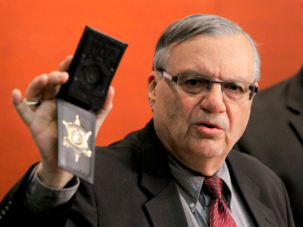 (Ross D. Franklin | AP file photo) Maricopa County Sheriff Joe Arpaio shows his badge as he holds a ceremony where 92 of his immigration jail officers, who lost their federal power to check whether inmates are in the county illegally, turn in their credentials after federal officials pulled the Sheriff's office immigration enforcement powers in Phoenix in December 2011.