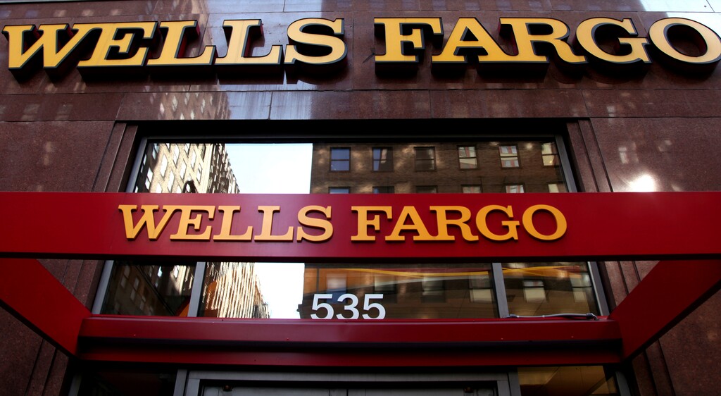 FILE - In this May 6, 2012, file photo, a Wells Fargo sign is displayed at a branch in New York. The nation's big bank regulator is faulting itself for failing to address the problems at Wells Fargo before it was too late. The inspector general at the Office of the Comptroller of the Currency said Wednesday, April 19, 2017, the Comptroller's examiners saw sales problems at Wells Fargo as early as 2010. (AP Photo/CX Matiash, File)