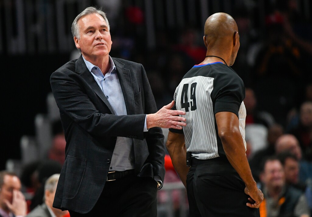 Houston Rockets coach Mike D'Antoni pats referee Tom Washington on the back after the hawks are called for a foul during the second quarter of an NBA basketball game Tuesday, March 19, in Atlanta. (AP Photo/John Amis)