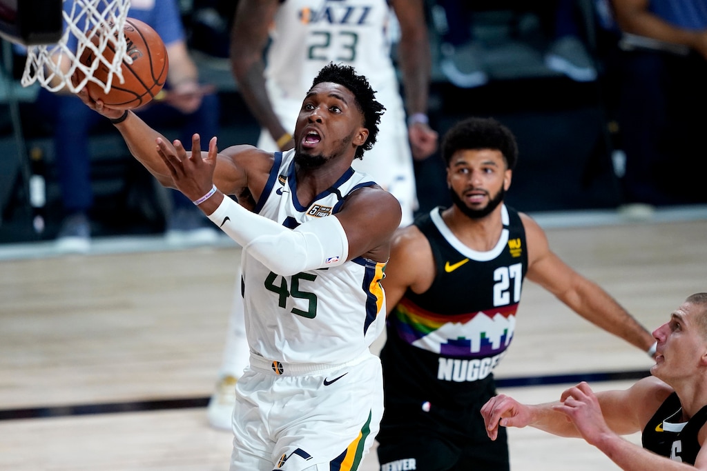(Ashley Landis | AP) Utah Jazz's Donovan Mitchell (45) drives as Denver Nuggets' Jamal Murray (27) looks on during the first half of an NBA basketball first round playoff game, Wednesday, Aug. 19, 2020, in Lake Buena Vista, Fla.