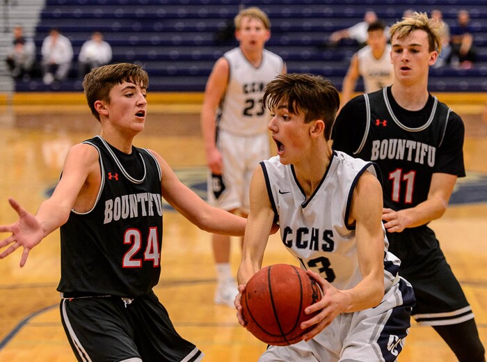 (Trent Nelson | The Salt Lake Tribune)  Bountiful's Camron Chism (24) and Corner Canyon's Hayden Welling (13) as Corner Canyon faces Bountiful in the title game of the Corner Canyon Tournament of Champions, high school boys' basketball in Draper, Saturday December 2, 2017.