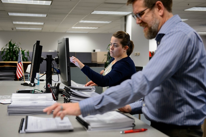 (Trent Nelson | The Salt Lake Tribune) Olivia Spencer and Bret Chappell sort through signed tax referendum petitions at the Salt Lake County Clerk's Office in Salt Lake City on Tuesday, Jan. 21, 2020.