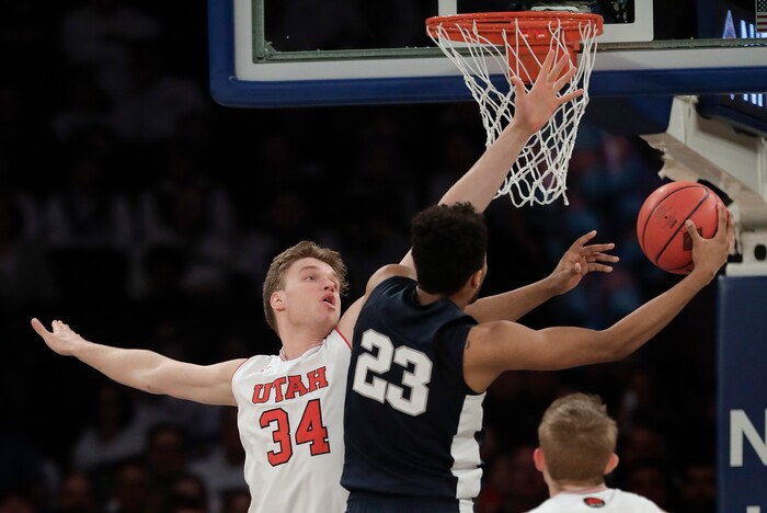 Penn State guard Josh Reaves (23) shoots next to Utah forward Jayce Johnson (34) in the first quarter of an NCAA college basketball game for the NIT championship Thursday, March 29, 2018, in New York. (AP Photo/Julie Jacobson)