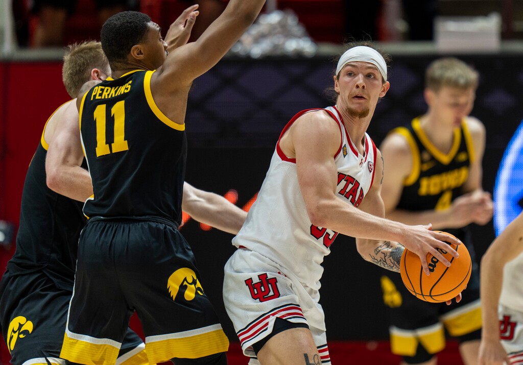 (Rick Egan | The Salt Lake Tribune) Utah Utes guard Gabe Madsen (55) looks for an open man, as Iowa Hawkeyes guard Tony Perkins (11) defends, in NIT Second Round action at the Jon M. Huntsman Center, on Sunday, March 24, 2024.