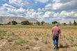 (Brooke Larsen | The Salt Lake Tribune) Brooks Behling walks across one of his dry alfalfa fields in Ferron on August 10, 2026.