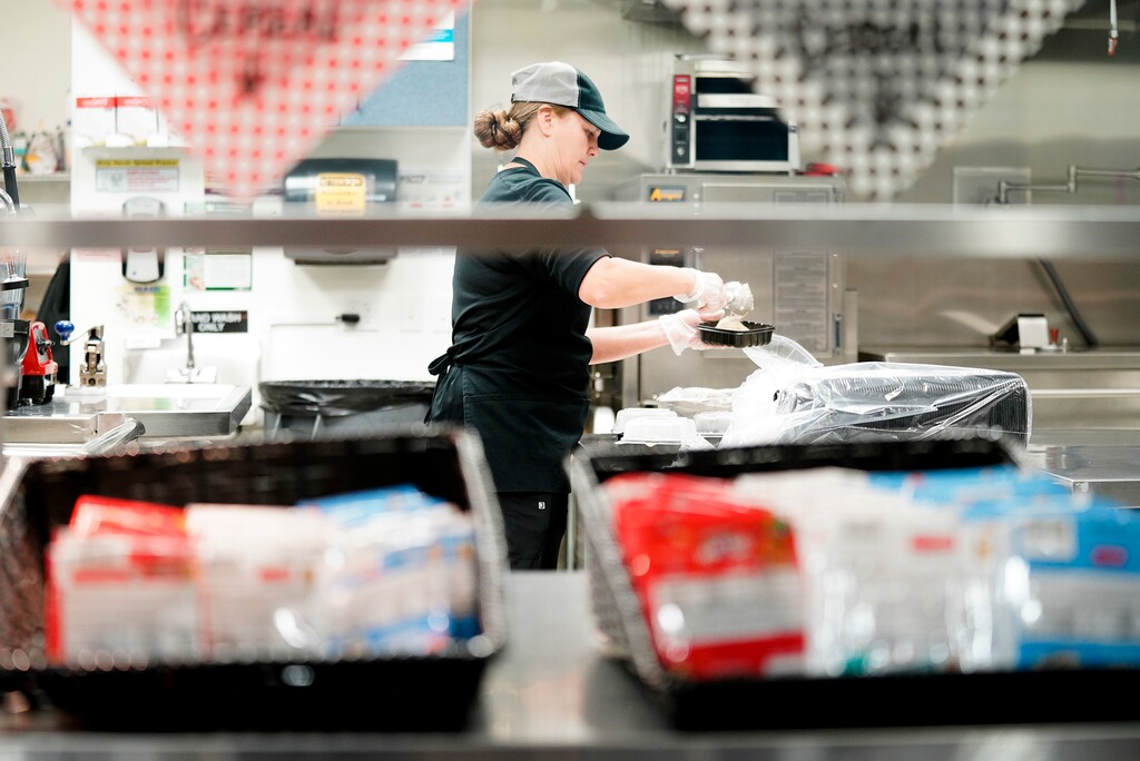 (Chris Bronson | Dairy West, sponsored) Lincoln Academy kitchen director Jodi Lum prepares breakfast for students on September 22 at the school in Pleasant Grove.