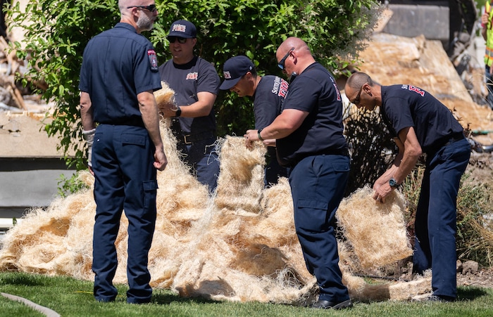 (Francisco Kjolseth | The Salt Lake Tribune) South Jordan firefighters prepare fire starter for a planned burn of a home where an owner kept a stockpile of explosives, on Tuesday, June 1, 2021. Residual explosives that had been mixed in a basement bathtub could not be safely removed and had to be burned off.