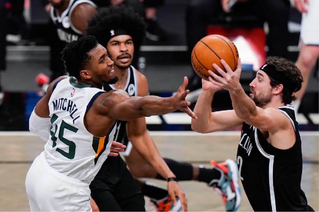 Utah Jazz's Donovan Mitchell (45) fights for control of the ball with Brooklyn Nets' Joe Harris (12) during the second half of an NBA basketball game Tuesday, Jan. 5, 2021, in New York. (AP Photo/Frank Franklin II)