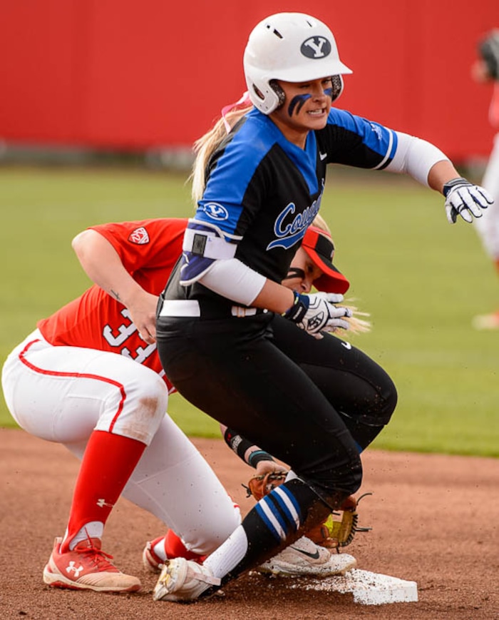 (Trent Nelson | The Salt Lake Tribune)  Utah Utes host the BYU Cougars, NCAA softball in Salt Lake City, Wednesday April 18, 2018. BYU outfielder Rylee Jensen (2) is safe at second base, with Utah shortstop Abby Robertson (33) fielding the ball.