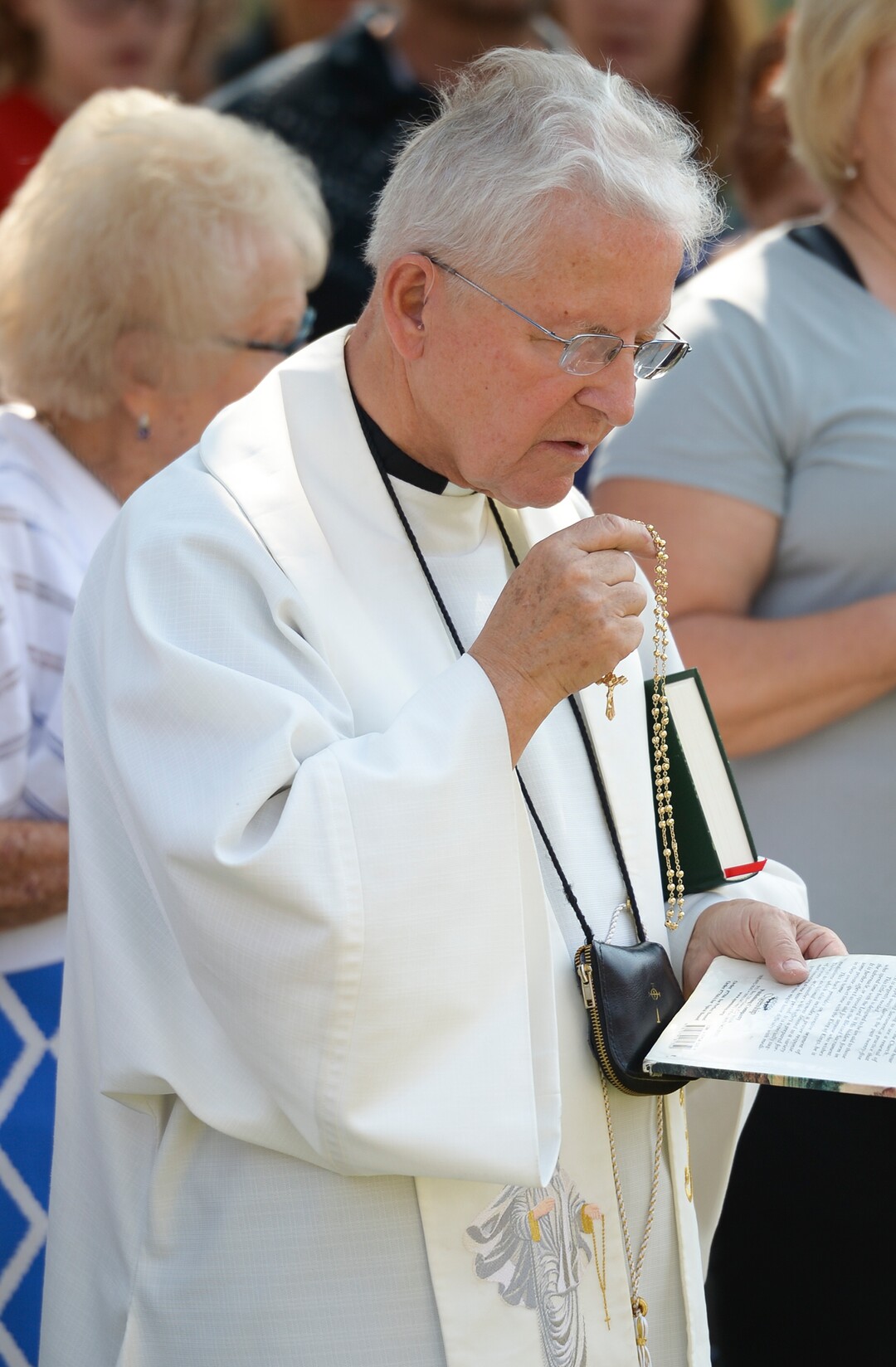 Leah Hogsten  |  The Salt Lake Tribune   Catholic priest, Rev. Jan Bednarz of St. Martin de Porres Parish in Taylorsville, leads the "blessed sacrament" and exorcism at the Planned Parenthood offices on the Feast of the Assumption. Bednarz was joined by the group, "40 Days for Life Utah," to protest Planned Parenthood. 