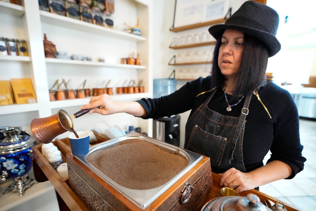 (Francisco Kjolseth | The Salt Lake Tribune) Elif Ekin, owner of Kahve Cafe at 57 S. 600 East in Salt Lake City, prepares Turkish coffee with a sand machine on Wednesday, Dec. 28, 2022. The cozy space full of nooks and small rooms doubles as an incubator space for artists and other creators.