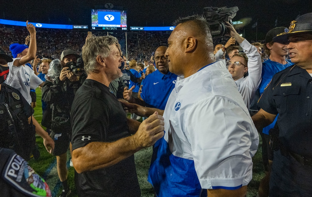 (Rick Egan | The Salt Lake Tribune) Utah Utes head coach Kyle Whittingham Brigham Young Cougars head coach Kalani Sitake meet at midfield as BYU defeats Utah 26-17 in football action between the Utah Utes and the Brigham Young Cougars at Lavell Edwards Stadium in Provo, on Saturday, Sept. 11, 2021.