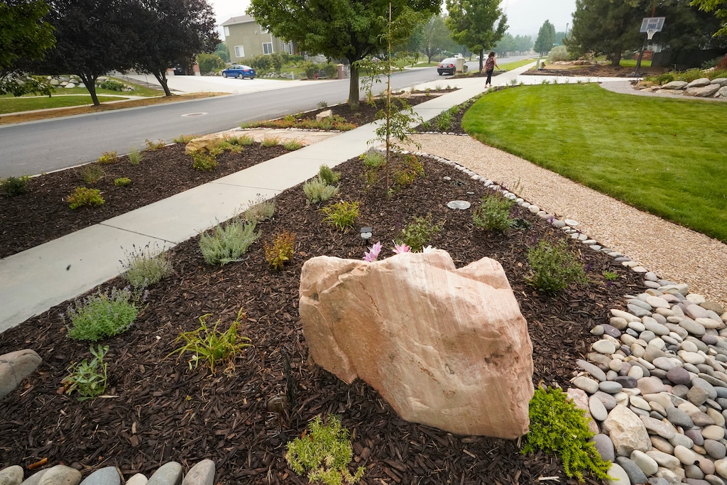 (Leah Hogsten | The Salt Lake Tribune) With the help of state-run rebate and incentive programs, A Draper resident turned her grass parking strips into a colorful, water-wise landscape. But not every city in the state offers the same incentives.