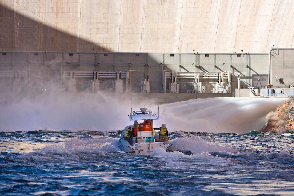  (Tribune file photo) A Park Service boat approaches the base of the Glen Canyon Dam where water is surging into the Colorado River on Wednesday, March 5, 2008. The water release is part of an ongoing experiment to see if a springtime influx of more water will improve fisheries downstream. 