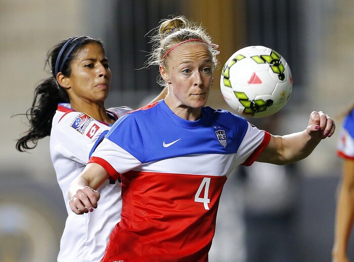 United States defender Becky Sauerbrunn (4) in action against Costa Rica midfielder Shirley Cruz (10) during the CONCACAF championship soccer match in Chester, Pa., Sunday, Oct. 26, 2014. The United States defeated Costa Rica 6-0. (AP Photo/Rich Schultz)
