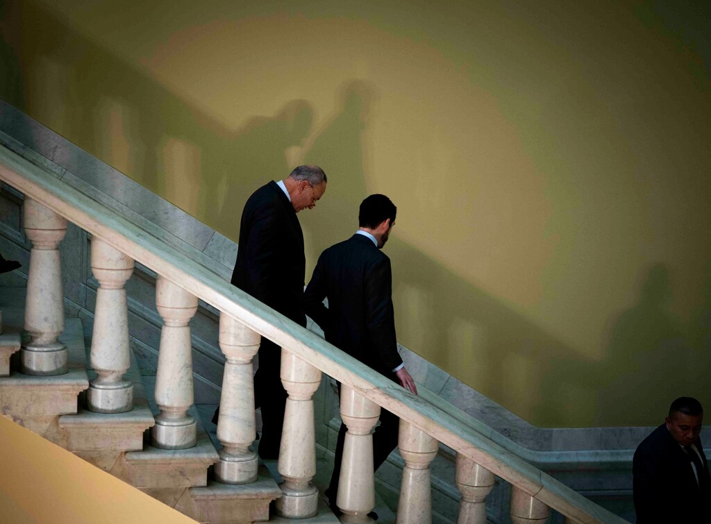 (Doug Mills | The New York Times) Senate Minority Leader Sen. Chuck Schumer of N.Y. walks back to his office with a members of his staff following a news conference in the Capitol as the Senate Impeachment trial continues in Washington on Wednesday, Jan. 22, 2020.
