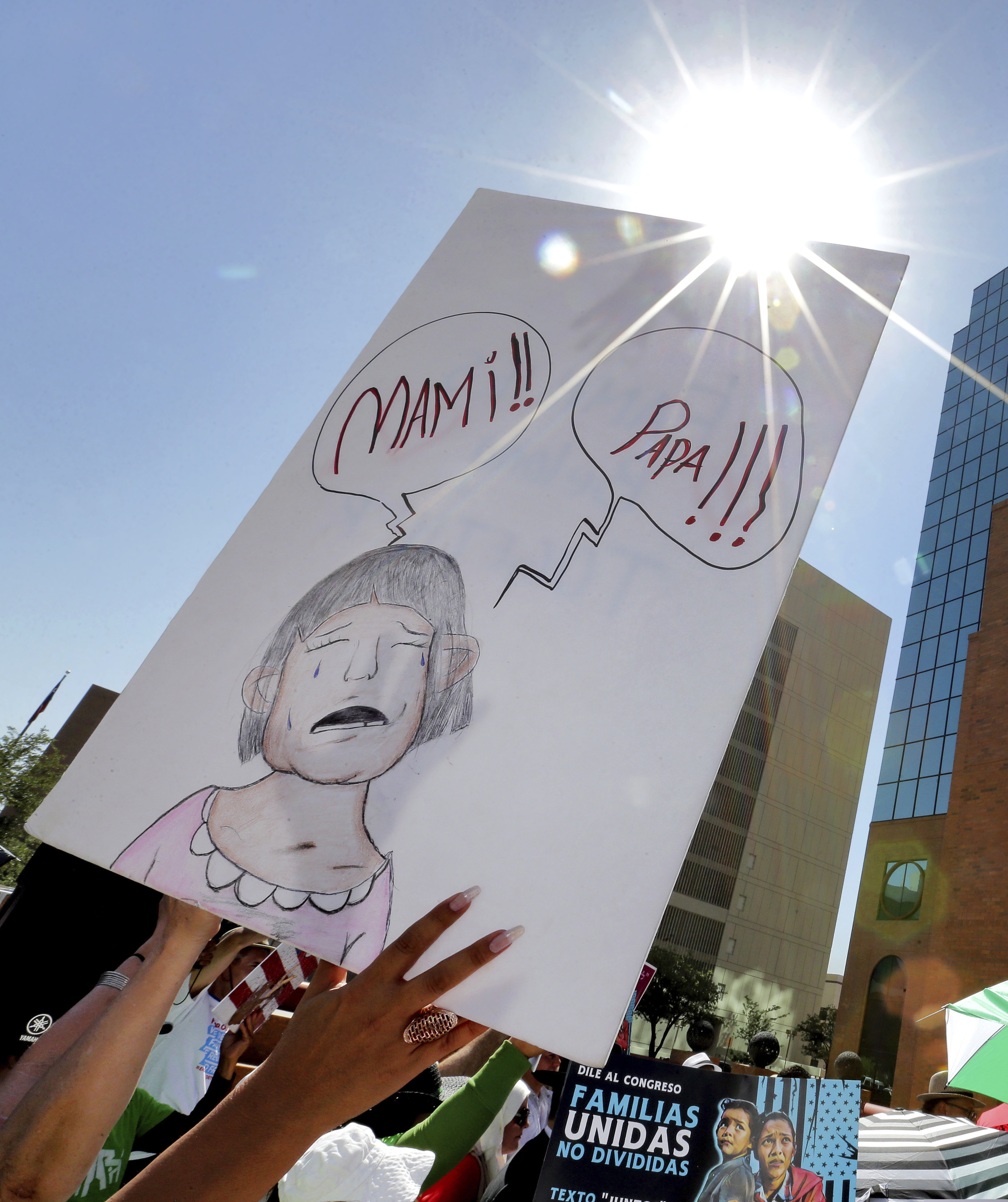 (Matt York | AP Photo) In this Tuesday, June 26, 2018, file photo, people protest immigration separation policies outside Federal Court in El Paso, Texas. Cases of children and families seeking refuge were being heard inside the courthouse. Half a dozen families who were separated from their children at the U.S.-Mexico border are still detained in Texas months after reuniting with their children. Many families had spent months apart after President Donald Trump's administration launched a zero-tolerance policy requiring anyone who crossed the border illegally to face criminal charges.