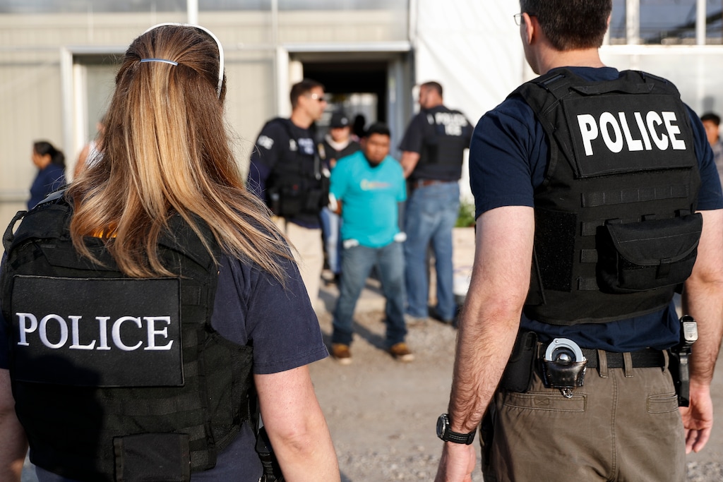 (John Minchillo | AP file photo) Government agents detain suspects during an immigration raid in Castalia, Ohio, on June 5, 2018. Regular raids are a key part of President Donald Trump's administration's crackdown on immigrants living in the U.S. illegally.