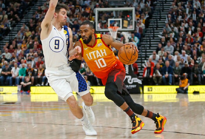 Utah Jazz guard Mike Conley (10) drives around Indiana Pacers guard T.J. McConnell (9) in the second half of an NBA basketball game Monday, Jan. 20, 2020, in Salt Lake City. (AP Photo/Rick Bowmer)