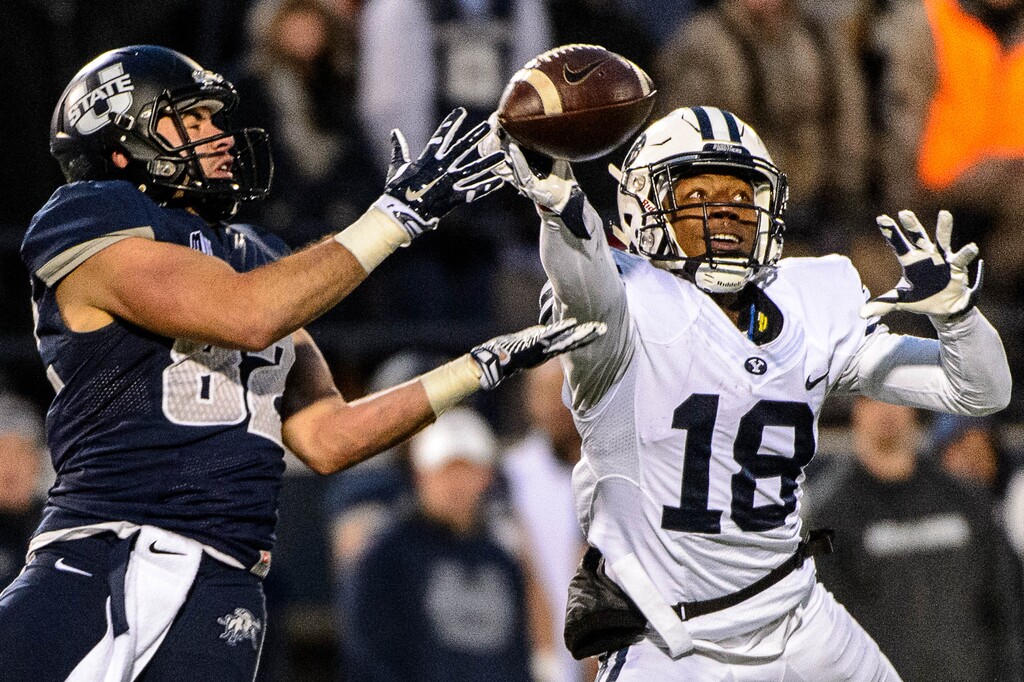Trent Nelson  |  The Salt Lake TribuneBrigham Young Cougars defensive back Michael Shelton (18) knocks the ball away from Utah State Aggies wide receiver Andrew Rodriguez (82) as Utah State hosts BYU, NCAA football in Logan, Saturday November 28, 2015.