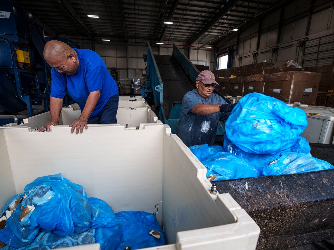 (Leah Hogsten | The Salt Lake Tribune) Wasatch Resource Recovery employees l-r Tommy Kojima and Brown Eyes Adair unload bags filled with ice cream sandwiches for processing. Wasatch Resource Recovery is UtahÕs first and only anaerobic digester which produces a fertilizer and natural gas from decomposing food. The facility processes organic waste which includes food scraps, liquid waste and manufacturing food waste. The process, in operation since 2019, turns the organic matter into sustainable resources, biogas and bio-based fertilizer and the facility will pilot a food scraps pickup program for residents.