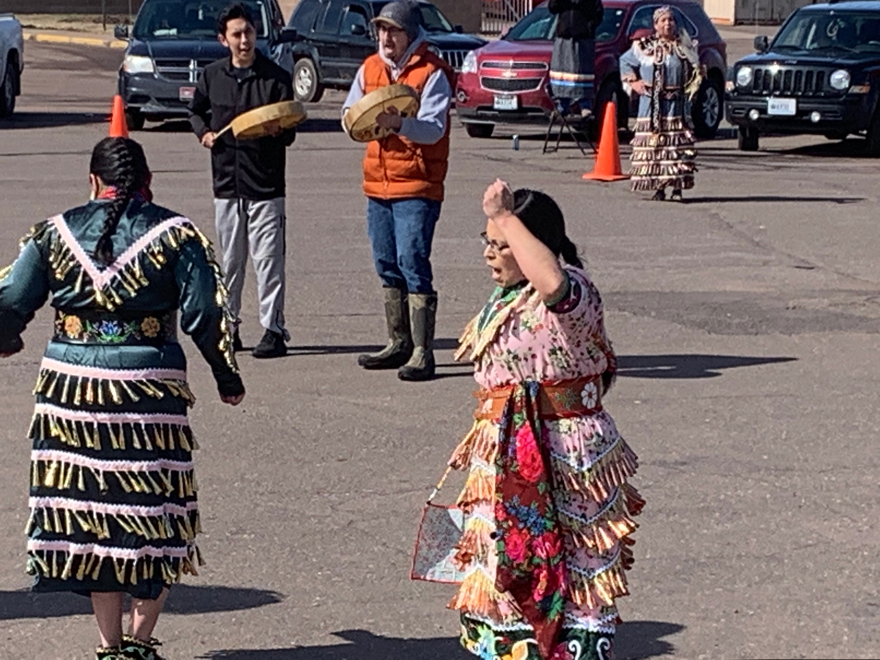(Lynn Maday Bigboy via AP) This Saturday, March 21, 2020, photo provided by Lynn Maday Bigboy shows singers and dancers at a social-distancing powwow outside the Bad River Casino in Ashland, Wis. People across Indian Country are organizing online and social-distancing powwows and posting videos of healing dances to offer support during the coronavirus pandemic.