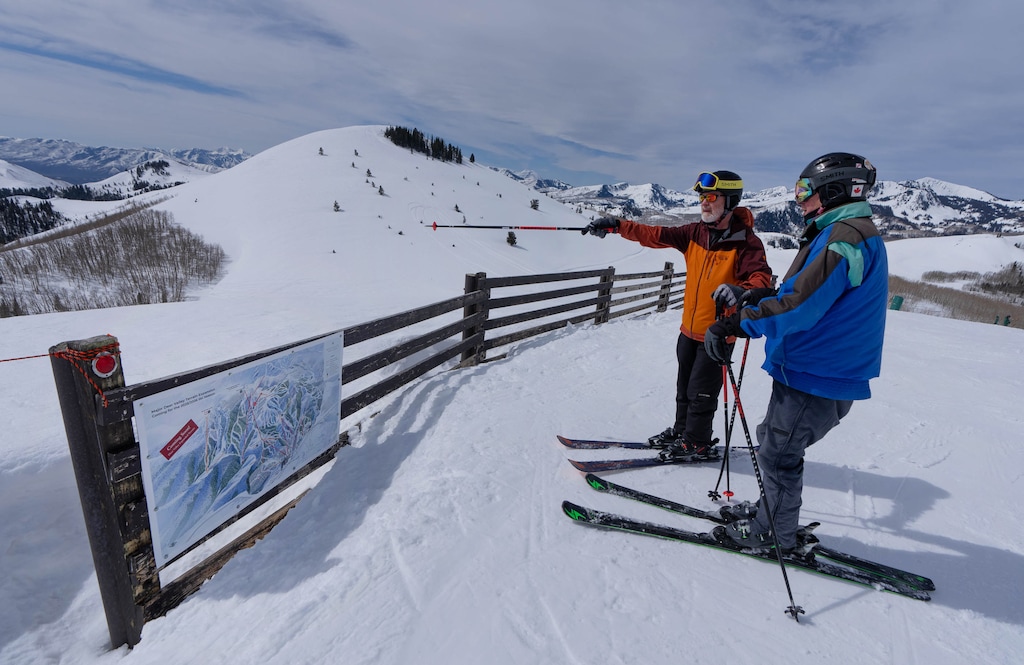 (Francisco Kjolseth | The Salt Lake Tribune) Skiers overlook expansion plans by Alterra Mountain Resorts, owner of Deer Valley, on Thursday, April 4, 2024. The addition of 3,700 acres of skiable terrain will include a 10-person gondola connecting East Village to Park Peak, in background, that will also feature a south-facing lodge. The Park City planning commission is mulling issuing a permit for a lift connecting the classic Deer Valley terrain to Park Peak.