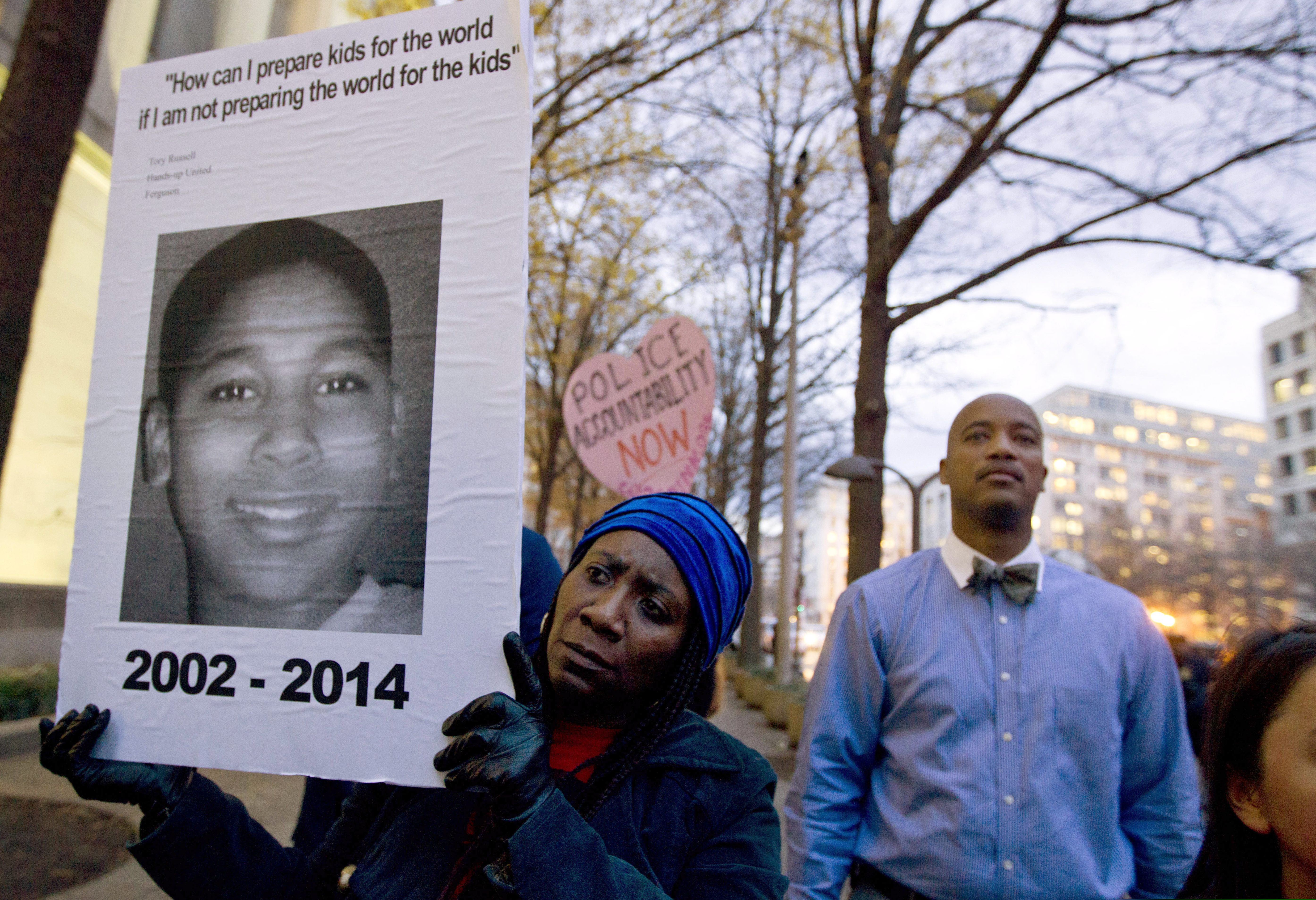 (Jose Luis Magana | AP photo)

In a Monday, Dec. 1, 2014, photo, Tomiko Shine holds up a picture of Tamir Rice during a protest in Washington, D.C. An arbitrator correctly decided that the white Cleveland police officer who shot and killed Tamir Rice should have been fired by the city for lying his on job application, a county judge in Cleveland ruled. Cuyahoga County Judge Joseph Russo upheld the 2017 firing of Timothy Loehmann in a ruling Wednesday, Dec. 18, 2019. Loehmann was cleared of criminal wrongdoing in the death of Tamir in November 2014 as he played with a pellet gun outside a Cleveland recreation center.