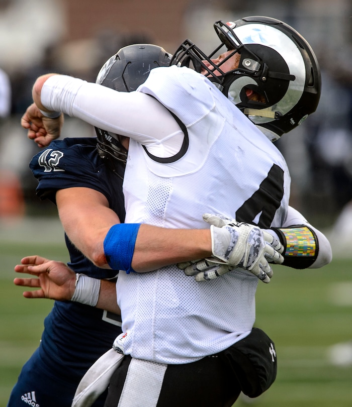 (Steve Griffin  |  The Salt Lake Tribune)  Highland quarterback Cole Peterson gets tackled by Corner Canyon's Mikey Petty just after he passes the ball during the Class 5A state quarterfinal football game at Corner Canyon in Draper Friday November 3, 2017.