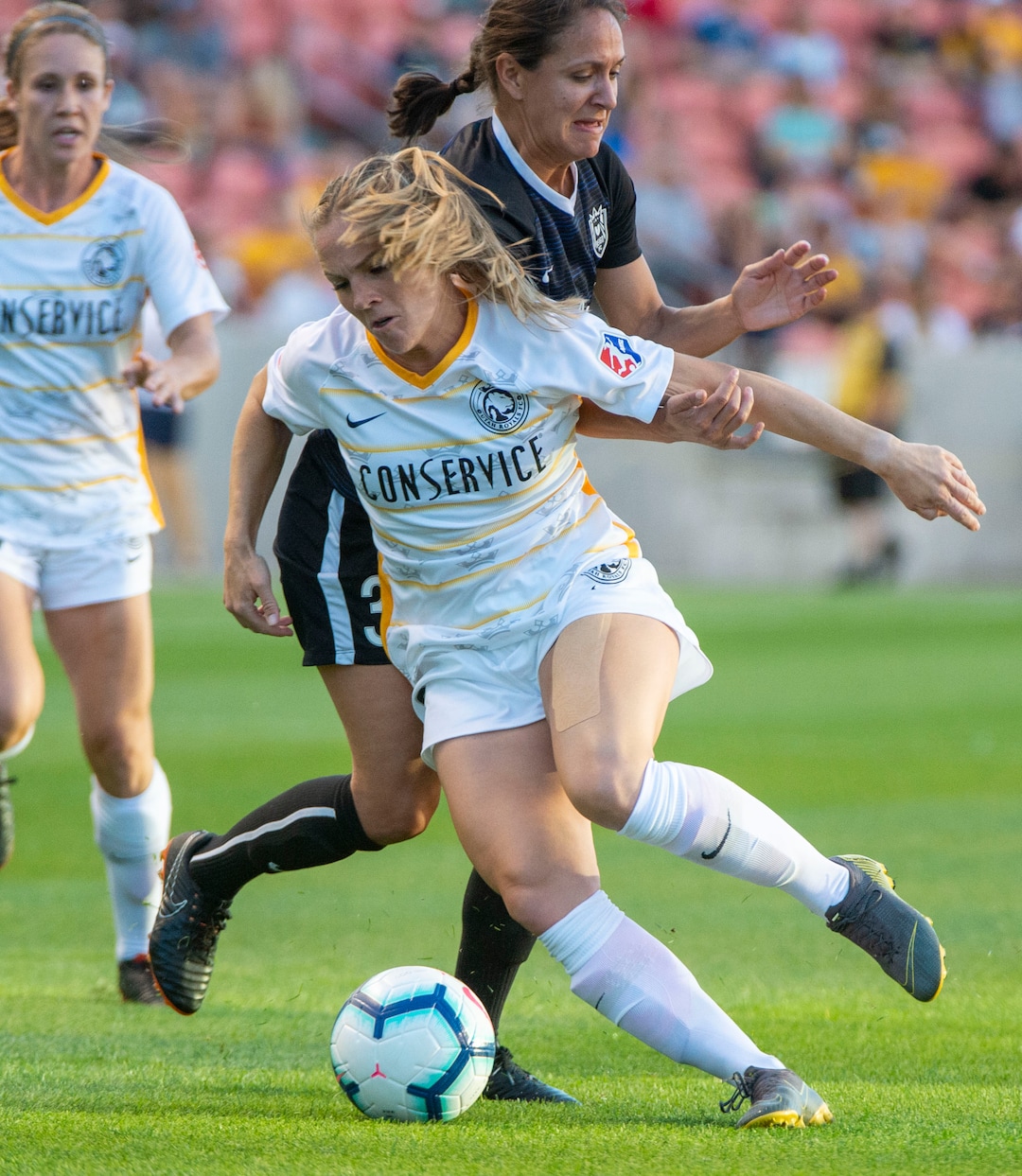 (Rick Egan  |  The Salt Lake Tribune)   Seattle Reign FC defender Theresa Nielsen (8) goes for the ball along with Seattle Reign FC defender Steph Cox, in soccer action between Utah Royals FC and Seattle Reign FC in Sandy, Friday, June 28, 2019.