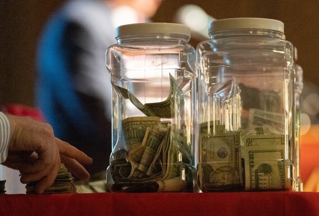 (Francisco Kjolseth | The Salt Lake Tribune) Money in jars at an event in Salt Lake County on Saturday, April 9, 2022.