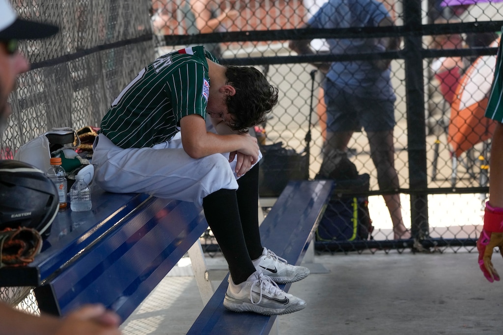 (Gerald Herbert | The Associated Press) A young athlete lowers his head while resting in Ruston, La., on Wednesday, Aug. 9, 2023.