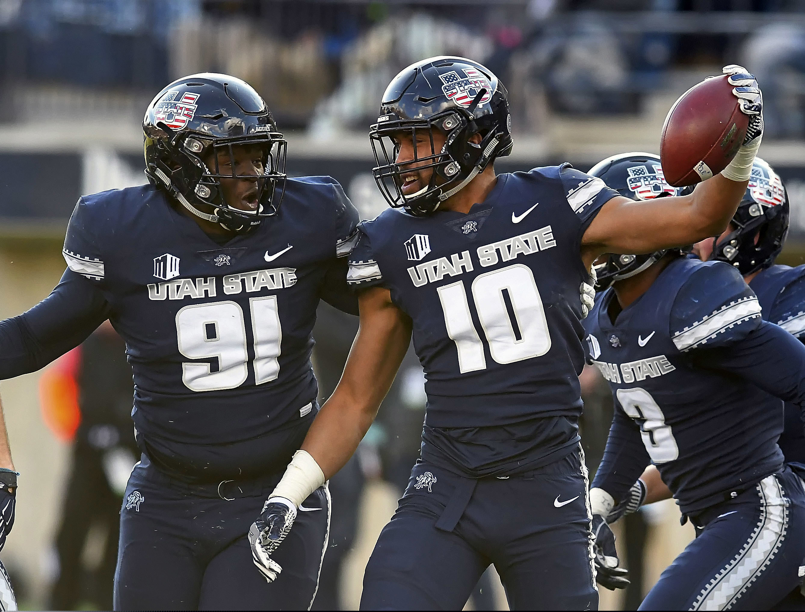 Utah State linebacker Tipa Galeai (10) celebrates with defensive end Devon Anderson (91) after he intercepted a San Jose State pass during an NCAA football game Saturday, Nov. 10, 2018, in Logan, Utah. (Eli Lucero/The Herald Journal via AP)