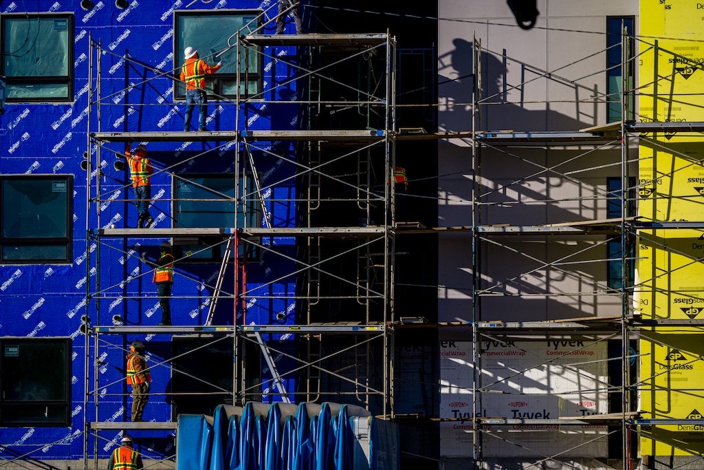 (Trent Nelson  |  The Salt Lake Tribune) Workers disassemble scaffolding during the construction of a new apartment complex in Salt Lake City on Monday, Dec. 29, 2025.
