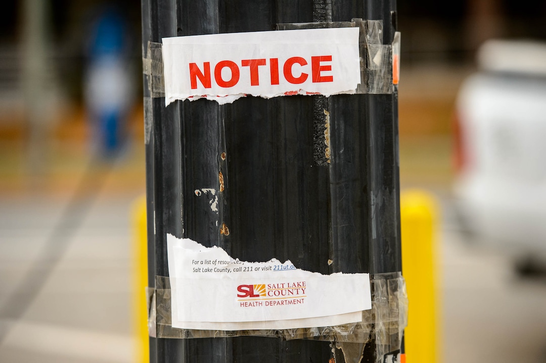 (Trent Nelson  |  The Salt Lake Tribune) A ripped notice by the Salt Lake County Health Department prohibiting camping near the Salt Lake City Library on Tuesday, Nov. 19, 2019.