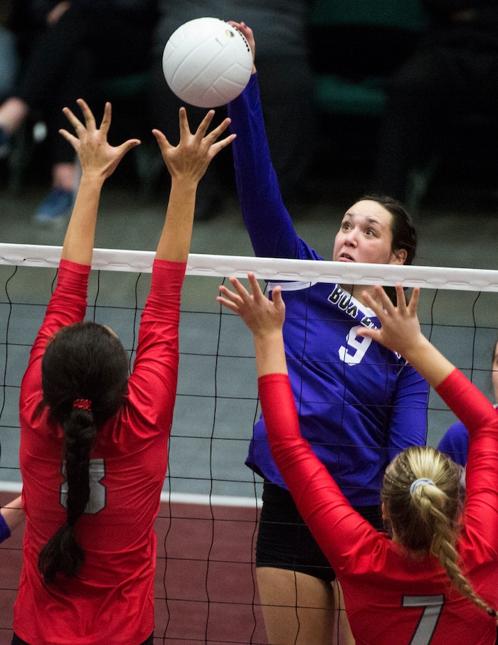 (Rick Egan  |  The Salt Lake Tribune)  Box Elder Bees Jaida Burt (9) hits the ball, as Bountiful Braves Baily Jenkins (7) and Kaybrie Pe’a (8) defend, in 5A volleyball championship game, Bountiful vs. Box Elder, at Utah Valley University, Saturday, November 4, 2017.